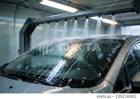 Automatic car wash system spraying water and soap on the windshield and roof Automatic car wash system spraying water and soap on the windshield and roof 139216902