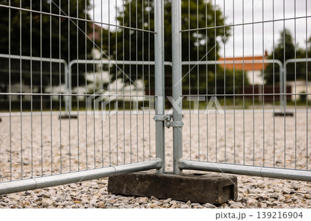 Temporary construction site fencing made of metal panels on a gravel surface Temporary construction site fencing made of metal panels on a gravel surface 139216904