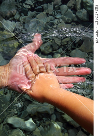 adult and children hands holding underwater 139217808