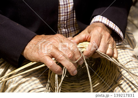 basketry craftsman hands working in Mediterranean basket basketry craftsman hands working in Mediterranean basket 139217831