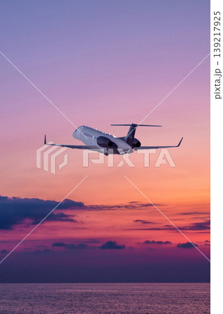 Executive aircraft take off over the ocean against the backdrop of scenic sunset sky 139217925