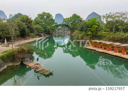 Beautiful old stone arch Fuli Bridge spans calm green river. China. 139217957
