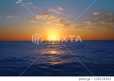 Sunrise sunset in ocean blue sea glowing sun 139218163