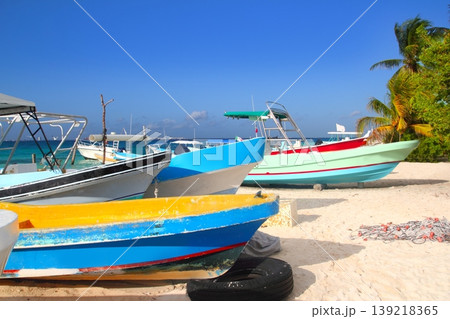 colorful tropical boats beached in sand Isla Mujeres colorful tropical boats beached in sand Isla Mujeres 139218365