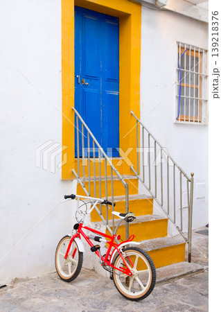 Ibiza white facade in blue door stairs Ibiza white facade in blue door stairs 139218376