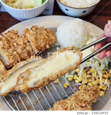 delicious crispy golden fried pork cutlet with melted mozzarella cheese delicious crispy golden fried pork cutlet with melted mozzarella cheese 139218435
