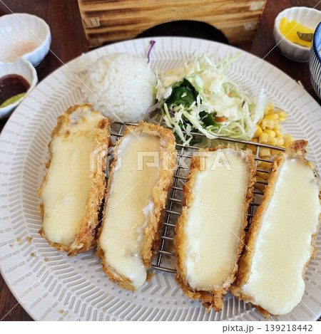 delicious crispy golden fried pork cutlet with melted mozzarella cheese delicious crispy golden fried pork cutlet with melted mozzarella cheese 139218442