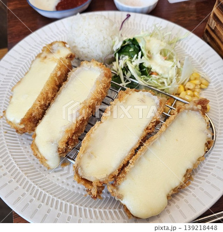 delicious crispy golden fried pork cutlet with melted mozzarella cheese 139218448