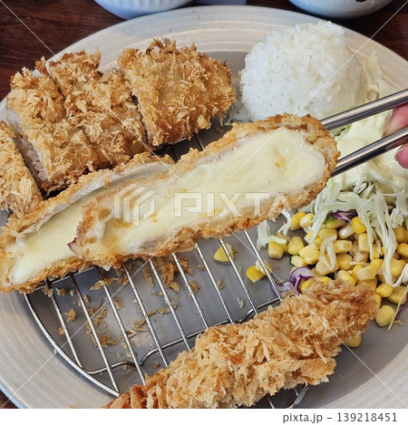 delicious crispy golden fried pork cutlet with melted mozzarella cheese delicious crispy golden fried pork cutlet with melted mozzarella cheese 139218451