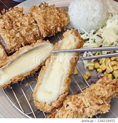 delicious crispy golden fried pork cutlet with melted mozzarella cheese delicious crispy golden fried pork cutlet with melted mozzarella cheese 139218455