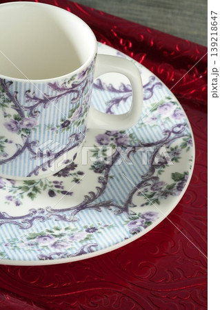 England old style tea cup and dish over red tray England old style tea cup and dish over red tray 139218647