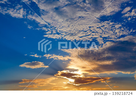 Sunset sky with golden and blue clouds Sunset sky with golden and blue clouds 139218724