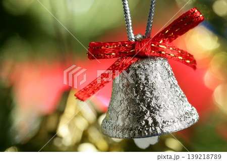 Silver bell in the christmas tree with red ribbon 139218789