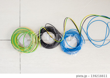 Electric cable coil in three colors black blue and earth Electric cable coil in three colors black blue and earth 139218811