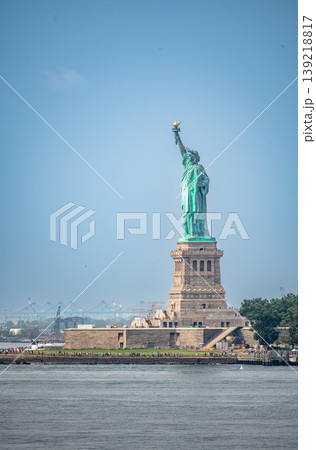 New york, usa august 16,2024. Statue of liberty greeting visitors on liberty island, iconic symbol of freedom and democracy against a blue new york harbor sky 139218817