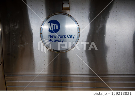 New york, usa august 16,2024. Mta logo on metallic nyc subway train door, symbolizing urban public transit, commuting, infrastructure and city mobility, nyc life New york, usa august 16,2024. Mta logo on metallic nyc subway train door, symbolizing urban public transit, commuting, infrastructure and city mobility, nyc life 139218821