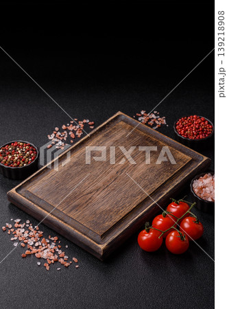 An empty wooden cutting board, kitchen utensils for food preparation. An empty cutting board 139218908