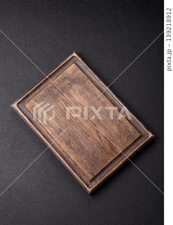 An empty wooden cutting board, kitchen utensils for food preparation. An empty cutting board An empty wooden cutting board, kitchen utensils for food preparation. An empty cutting board 139218912