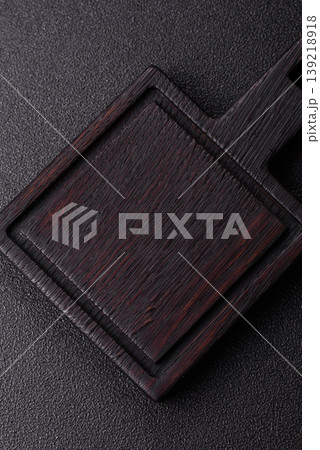 An empty wooden cutting board, kitchen utensils for food preparation. An empty cutting board 139218918