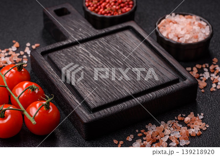 An empty wooden cutting board, kitchen utensils for food preparation. An empty cutting board An empty wooden cutting board, kitchen utensils for food preparation. An empty cutting board 139218920