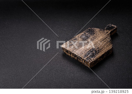 An empty wooden cutting board, kitchen utensils for food preparation. An empty cutting board An empty wooden cutting board, kitchen utensils for food preparation. An empty cutting board 139218925