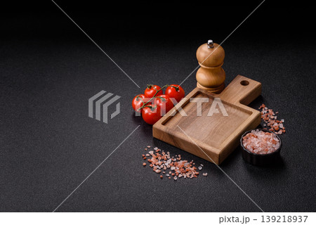 An empty wooden cutting board, kitchen utensils for food preparation. An empty cutting board 139218937
