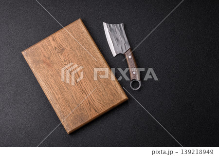 An empty wooden cutting board, kitchen utensils for food preparation. An empty cutting board 139218949