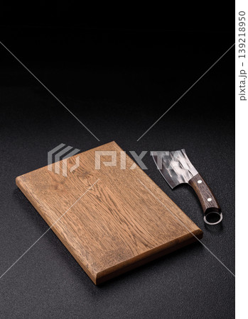 An empty wooden cutting board, kitchen utensils for food preparation. An empty cutting board 139218950