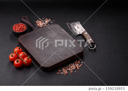 An empty wooden cutting board, kitchen utensils for food preparation. An empty cutting board An empty wooden cutting board, kitchen utensils for food preparation. An empty cutting board 139218953