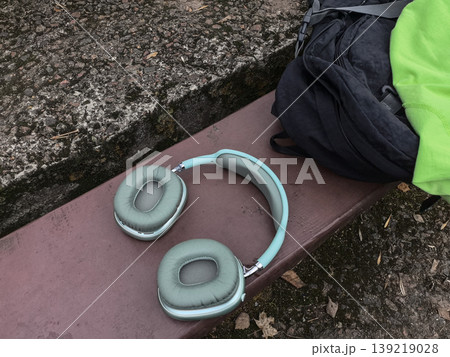 Modern Wireless Headphones on a Park Bench Modern Wireless Headphones on a Park Bench 139219028