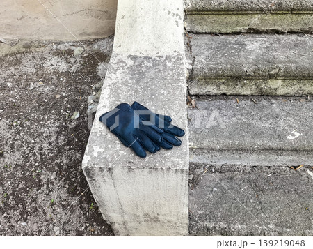 Black leather gloves on concrete ledge Black leather gloves on concrete ledge 139219048