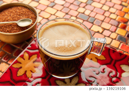 Coffee glass cup with cream on tiles red table Coffee glass cup with cream on tiles red table 139219106