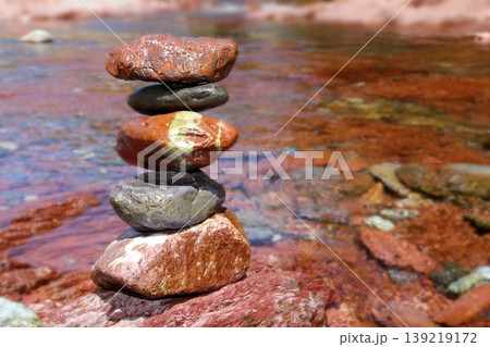 Rolling stones stacked red rodeno limestone in river 139219172