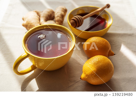 Flat Lay with Lemon Tea, Ginger and Honey on Light Table 139219480