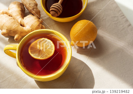 Flat Lay with Lemon Tea, Ginger and Honey on Light Table 139219482