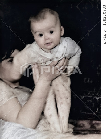A vintage portrait of a little boy and his mother holding her son. Retro photo, 1968. A vintage portrait of a little boy and his mother holding her son. Retro photo, 1968. 139220533