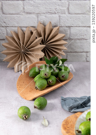 Fresh green feijoa fruit on a rustic platter Fresh green feijoa fruit on a rustic platter 139220597