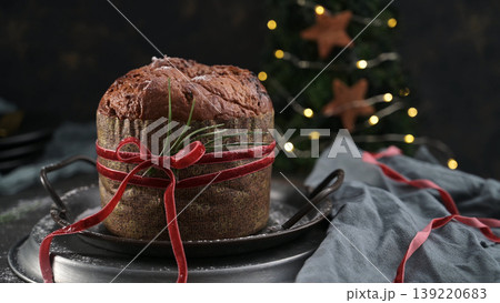 Festive Panettone Cake Wrapped with Red Ribbon on a Metal Stand Festive Panettone Cake Wrapped with Red Ribbon on a Metal Stand 139220683