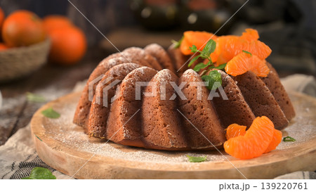 Glazed Orange Bundt Cake with Fresh Tangerine Slices and Powdered Sugar 139220761