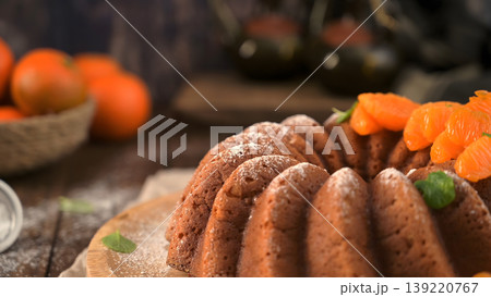 Glazed Orange Bundt Cake with Fresh Tangerine Slices and Powdered Sugar Glazed Orange Bundt Cake with Fresh Tangerine Slices and Powdered Sugar 139220767