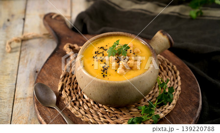 Creamy Pumpkin and Chickpea Soup in a Ceramic Bowl with Black Sesame Seeds Creamy Pumpkin and Chickpea Soup in a Ceramic Bowl with Black Sesame Seeds 139220788