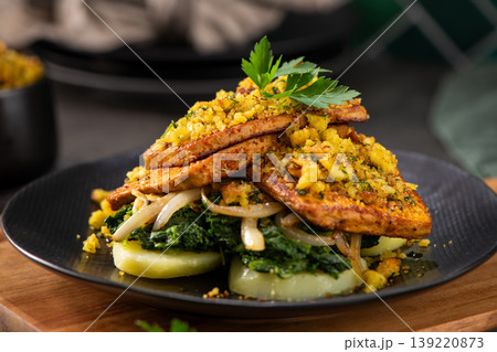 Gourmet Plant-Based Tofu Steak with Herb Crumble and Sauteed Greens Gourmet Plant-Based Tofu Steak with Herb Crumble and Sauteed Greens 139220873