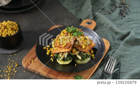 Crispy Herb Crusted Tofu over Sauteed Greens and Potatoes 139220879