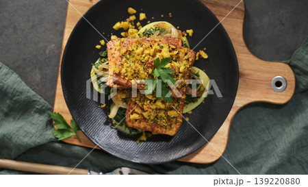 Crispy Breaded Tofu Steaks Served Over Sauteed Spinach and Onions on a Modern Black Plate Crispy Breaded Tofu Steaks Served Over Sauteed Spinach and Onions on a Modern Black Plate 139220880