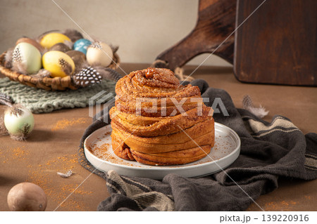 Artisan Easter Cinnamon Roll with Pastel Eggs and Feathers Artisan Easter Cinnamon Roll with Pastel Eggs and Feathers 139220916