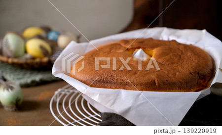 Golden Brown Pao de Lo Sponge Cake in Parchment Paper with Easter Eggs Golden Brown Pao de Lo Sponge Cake in Parchment Paper with Easter Eggs 139220919