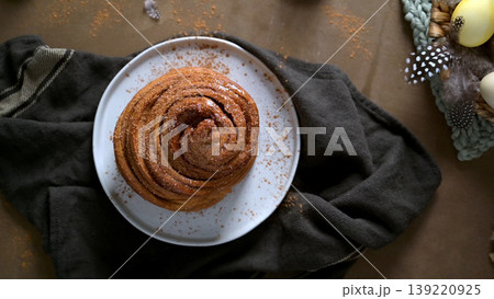 Freshly Baked Cinnamon Roll on a White Plate with Rustic Decor 139220925