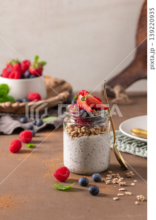 Healthy Chia Pudding Parfait with Granola and Fresh Berries in a Glass Jar 139220935