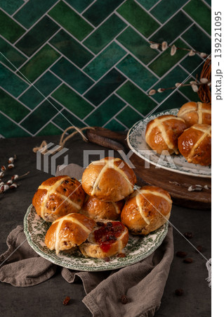Festive Easter Hot Cross Buns Display with Green Herringbone Tile Background Festive Easter Hot Cross Buns Display with Green Herringbone Tile Background 139221095