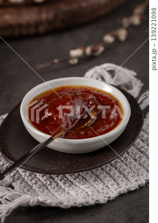 Fruit Jam in White Bowl on Rustic Tabletop with Pussy Willow Accents 139221098